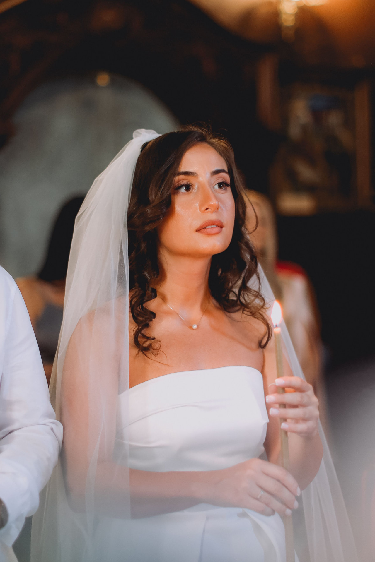Bride holding a candle in church