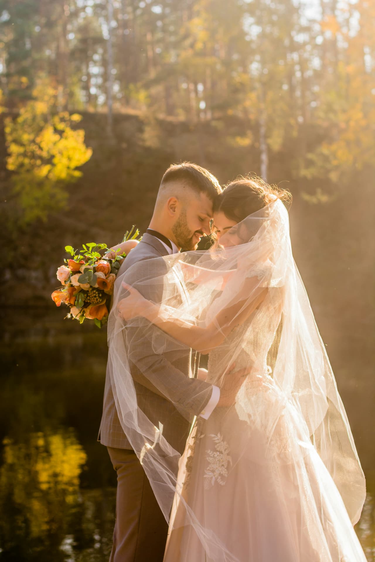 Bride and groom under veil at golden hour
