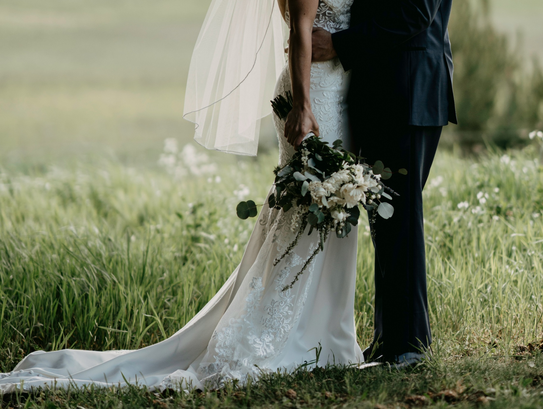 Bride and groom in meadow