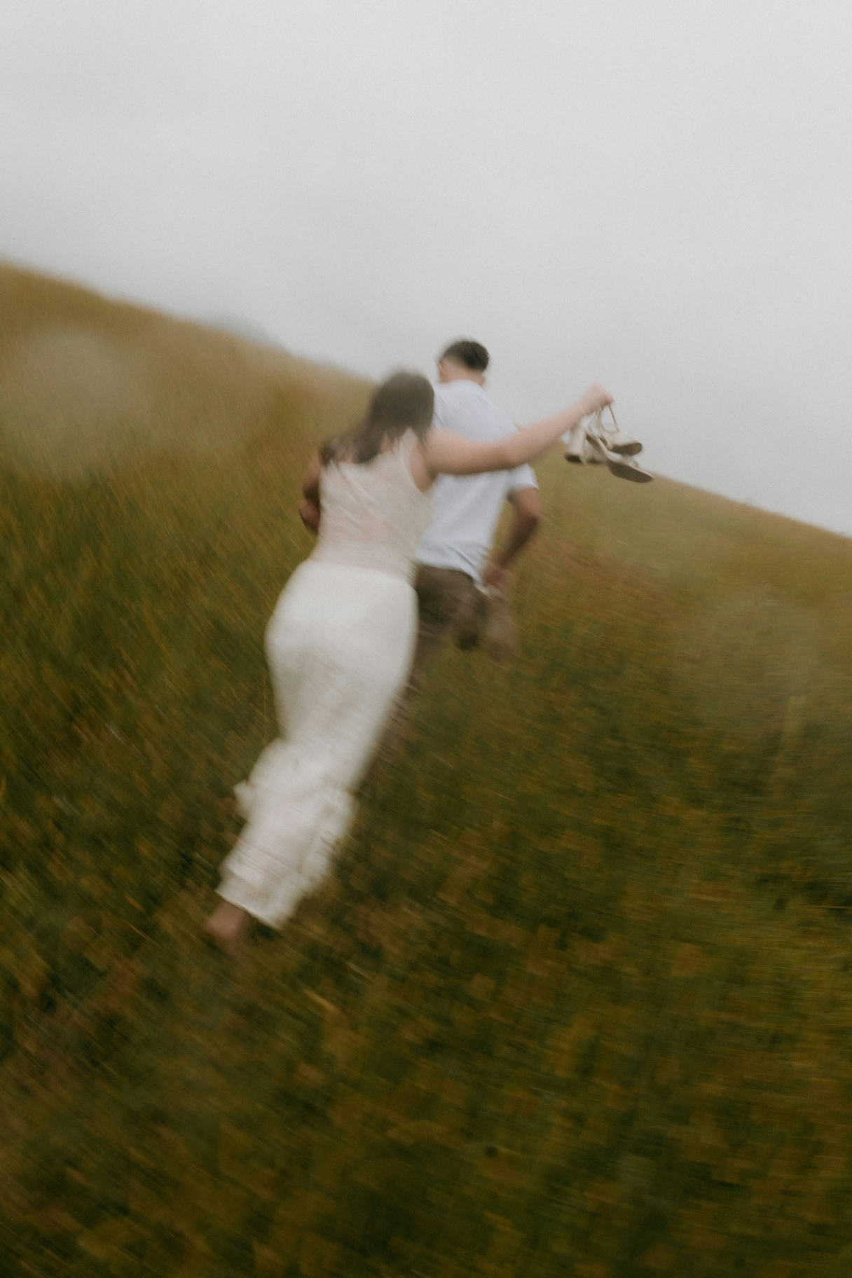 Couple running in field